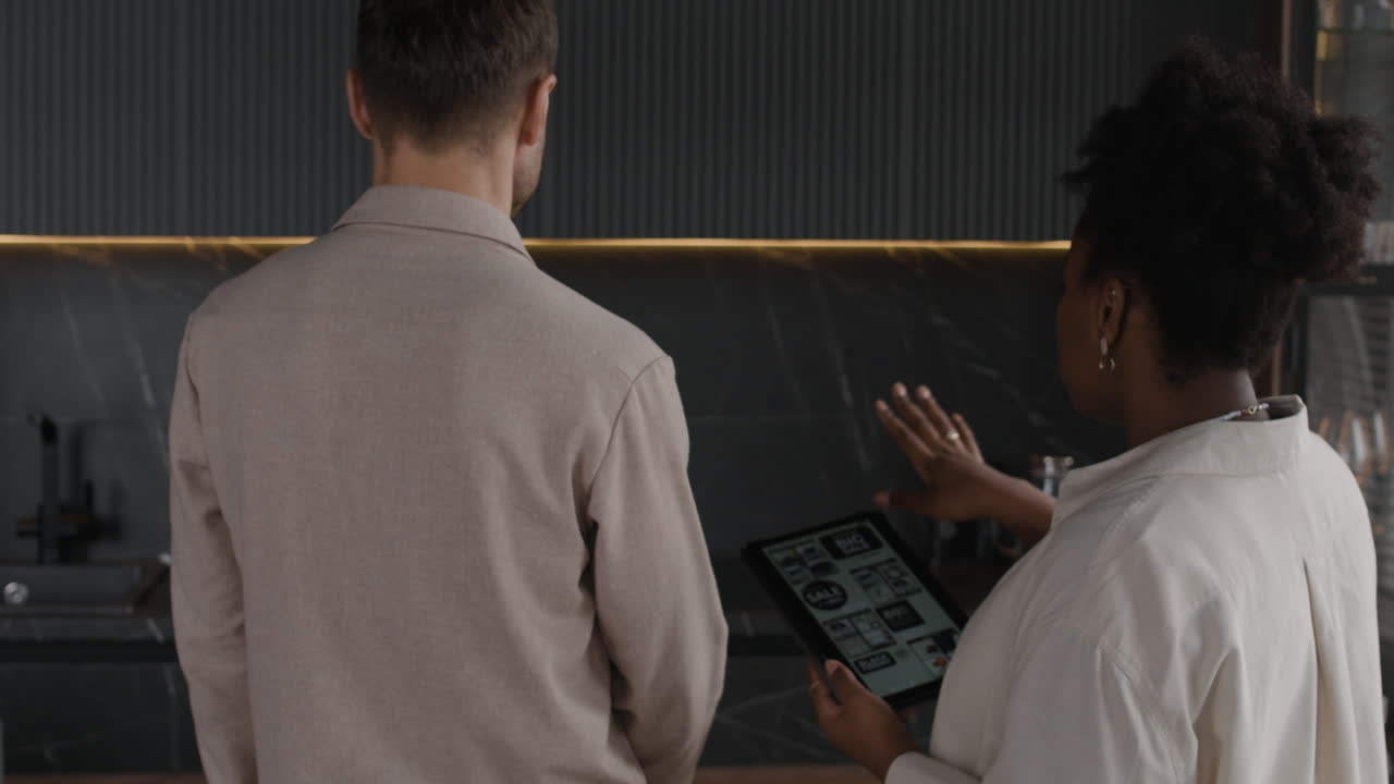 People looking at tablet in kitchen