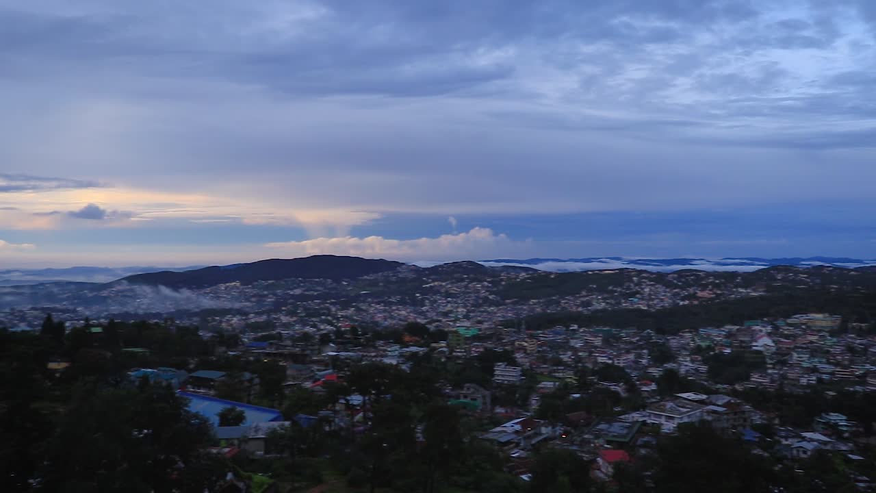 downtown city view with dramatic cloudy sky at evening from mountain top video is taken at shillong meghalaya india