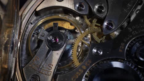 pocket watch back open to show movement close up