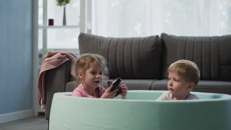 Kids-throw-balls-and-find-joystick-sitting-in-dry-pool