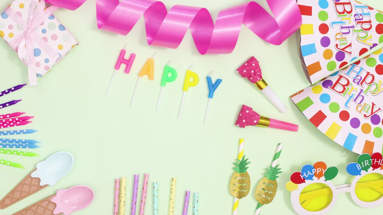 Birthday party decoration and happy birthday candles appear on green theme. Stop motion