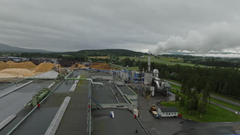 Smoke-Coming-Out-On-Chimney-Of-Industrial-Plant-Of-Wood-Manufacturer-In-Braskereidfoss,-Norway