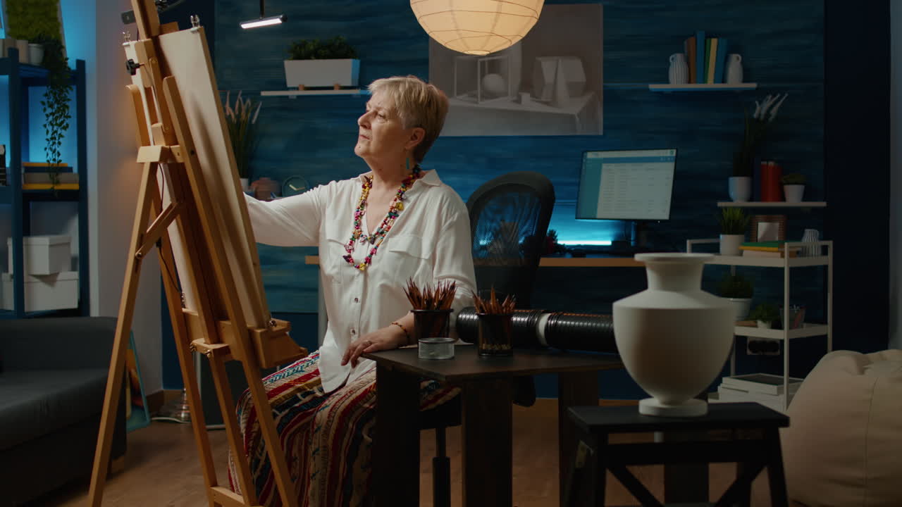 Retired woman with art and craft hobby drawing vase