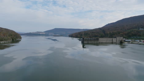 Aerial-footage-over-the-Nickajack-Lake-rotating-around-Historic-Hales-Dam-Powerhouse-in-the-morning-in-Autumn-in-Tennessee