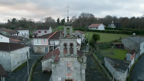 aerial pullback establish of old weathered broken down church in banos de molgas