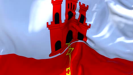 gibraltar flag waving in wind slow motion animation . 4k realistic fabric texture flag smooth blowing on a windy day continuous seamless loop background.