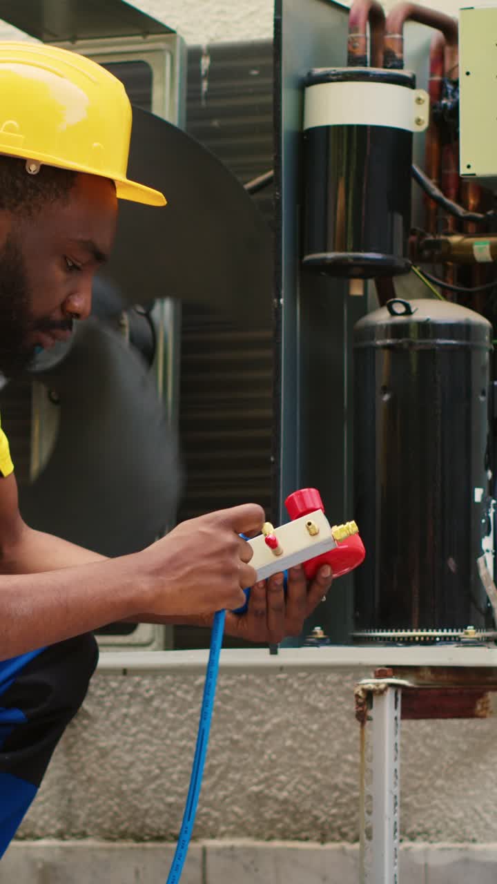 Vertical video Wireman does air conditioner maintenance