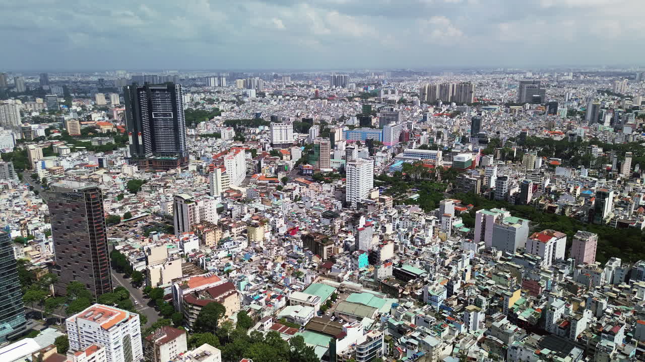High angle establishing of Ho Chi Minh City skyline, skyscrapers and rooftops under hazy sky, panoramic aerial