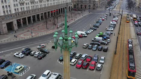 Aerial-view-of-a-traditional-street-light-and-a-tram-arriving-at-the-Konstytucji-Square-in-Warsaw,-Poland