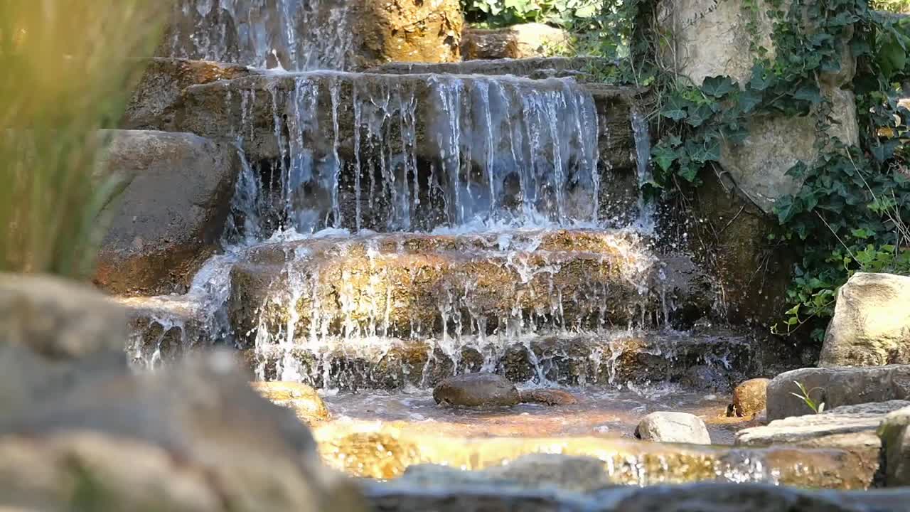Waterfall cascading over rocks with ivy