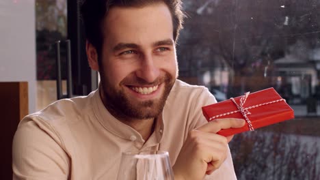 man receiving a gift in a restaurant