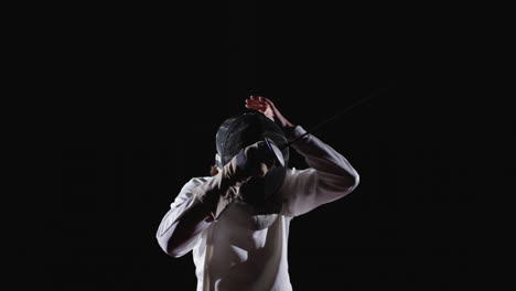 a fencer in action during a competition.