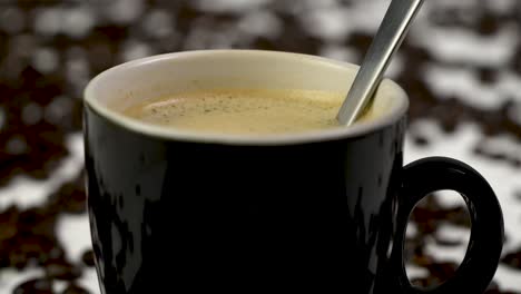 steady shot of someone stirring a coffee