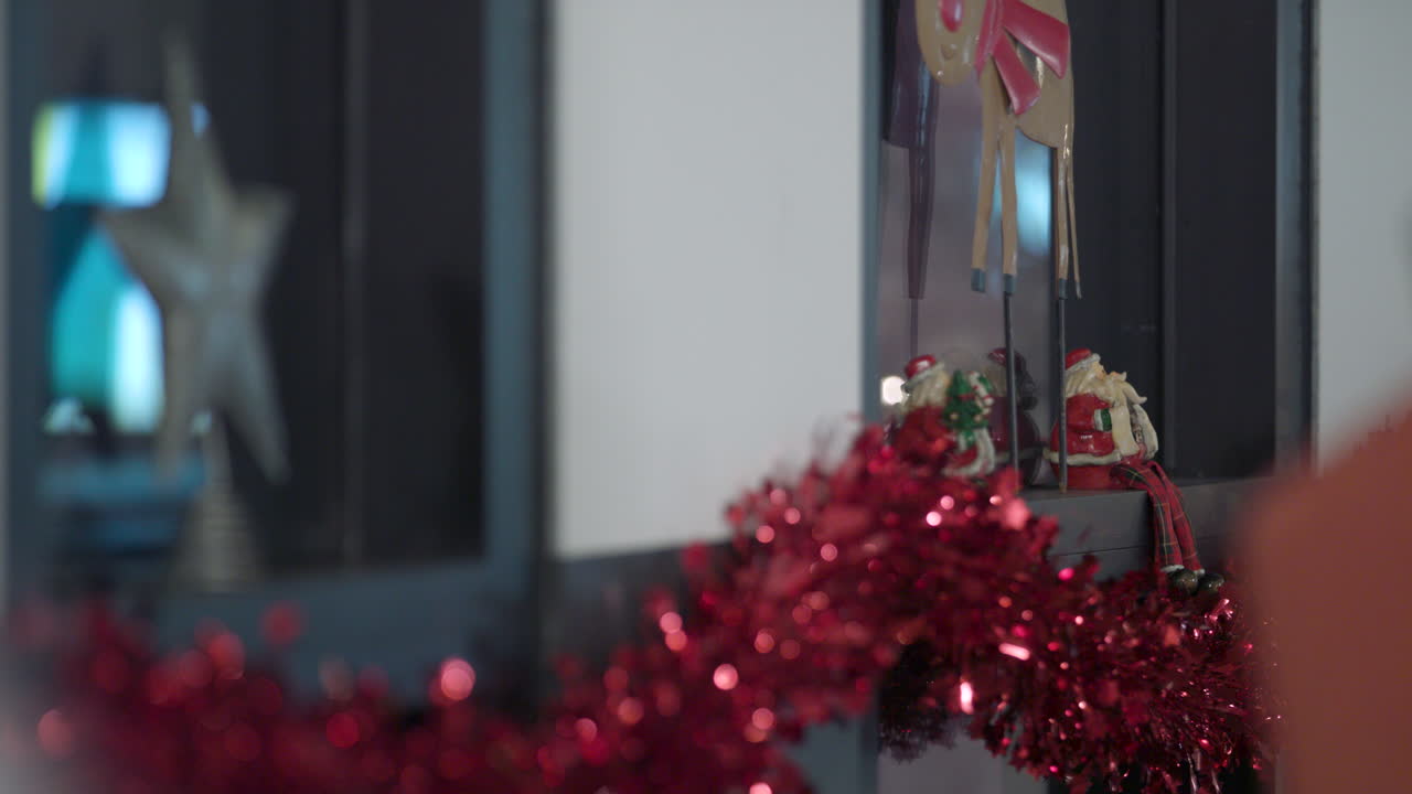 A wall decorated with red garland and Christmas decorations ready for a family celebration