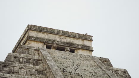 close up of historical chichen itza pyramid in yucatan, mexico on cloudy day