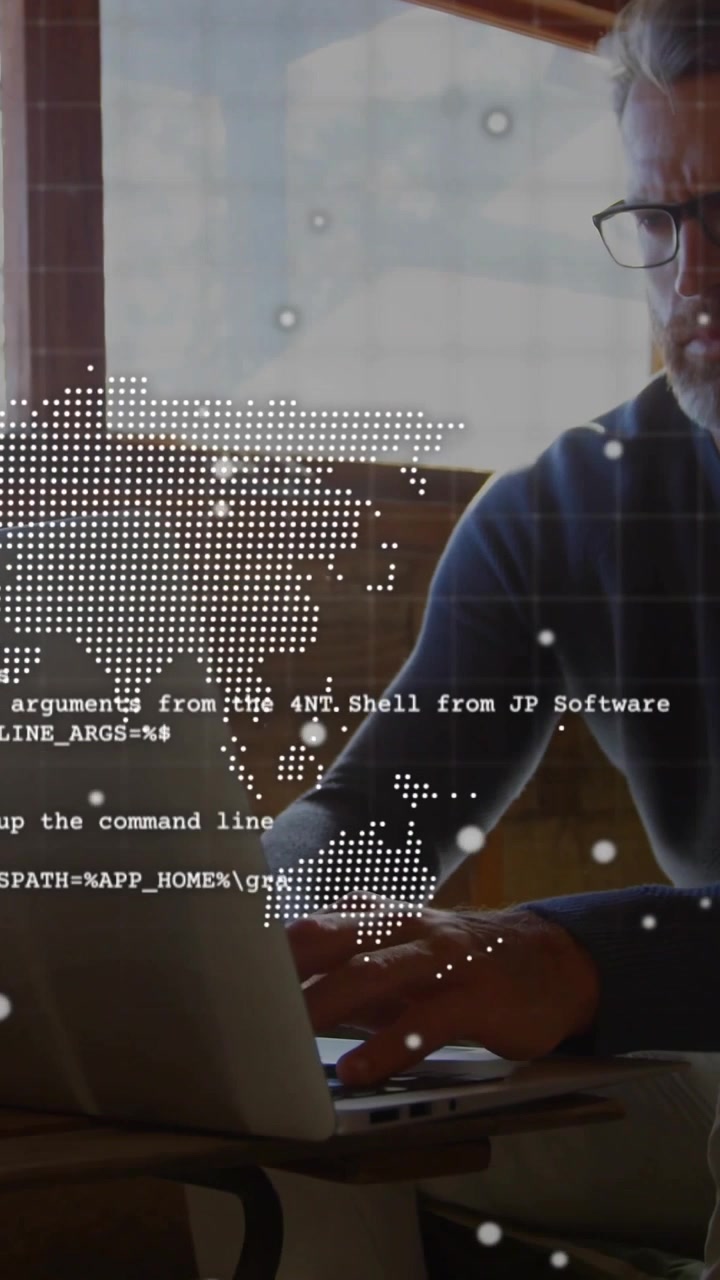 Vertical video: Man typing on laptop, activating world map and console HUD while debugging code