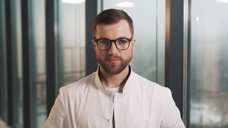 Close-up-of-a-male-doctor-looking-at-the-camera-and-smiling