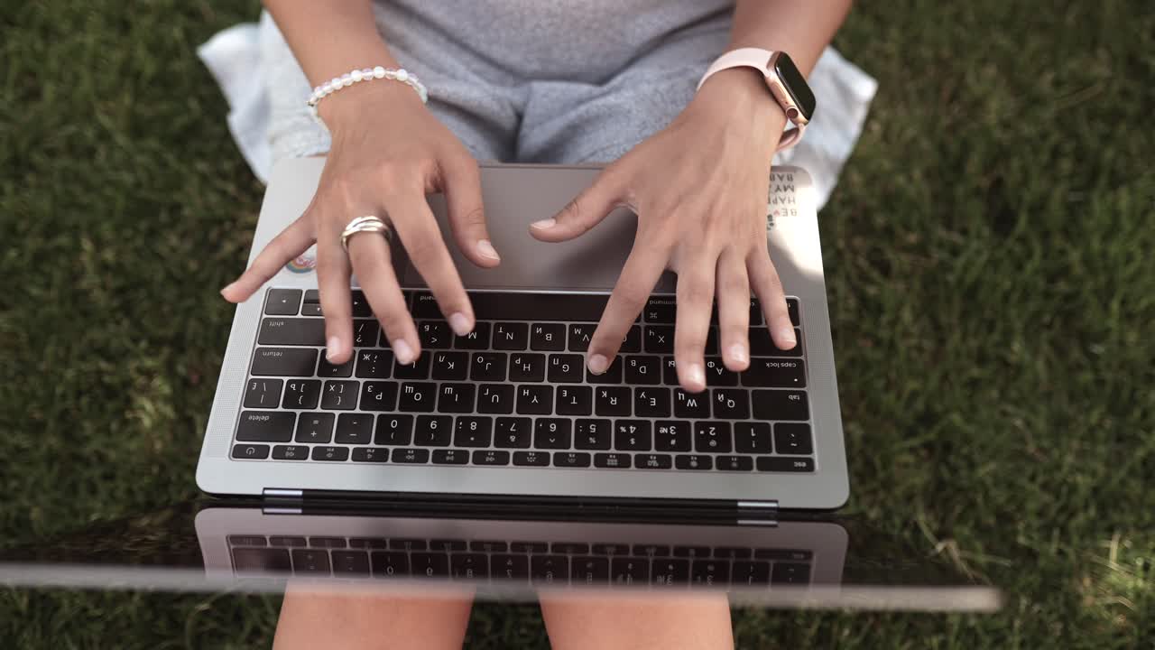 Woman Working on a Laptop Outdoors