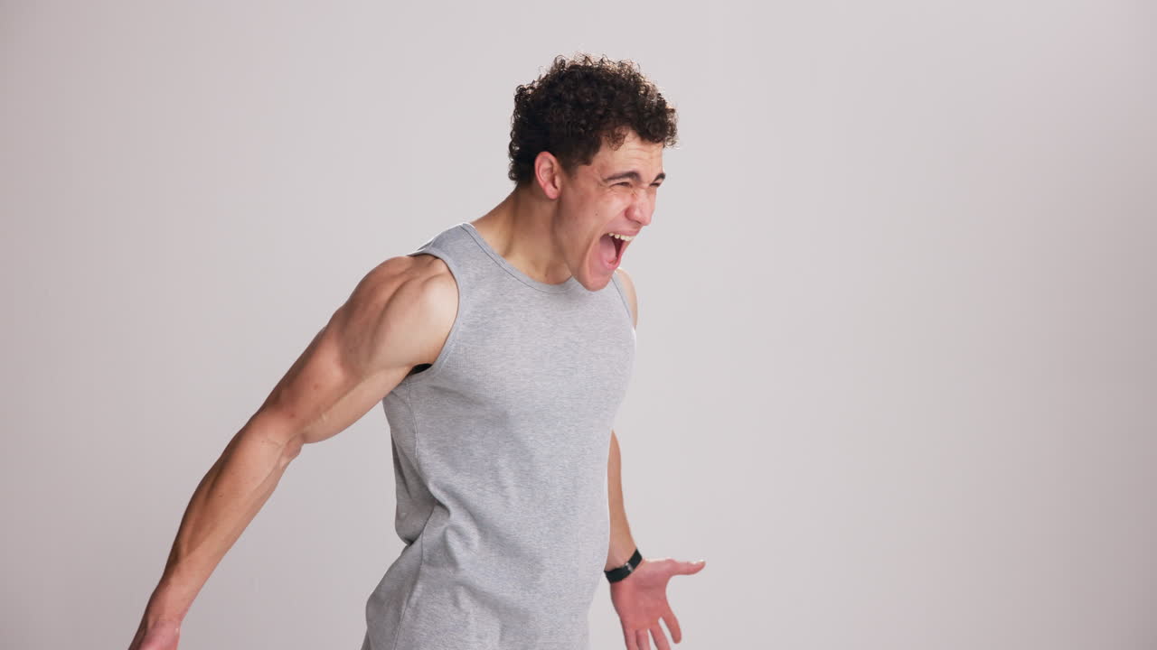 Muscular Young Man Shouting with Intense Effort