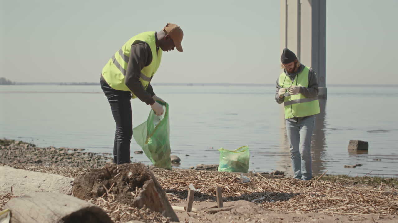 Environmental Volunteers Picking Up Trash on Shore