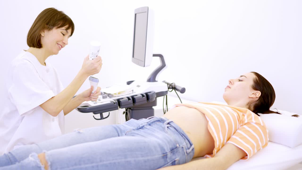 Doctor getting ready for an ultrasound to a pregnant woman