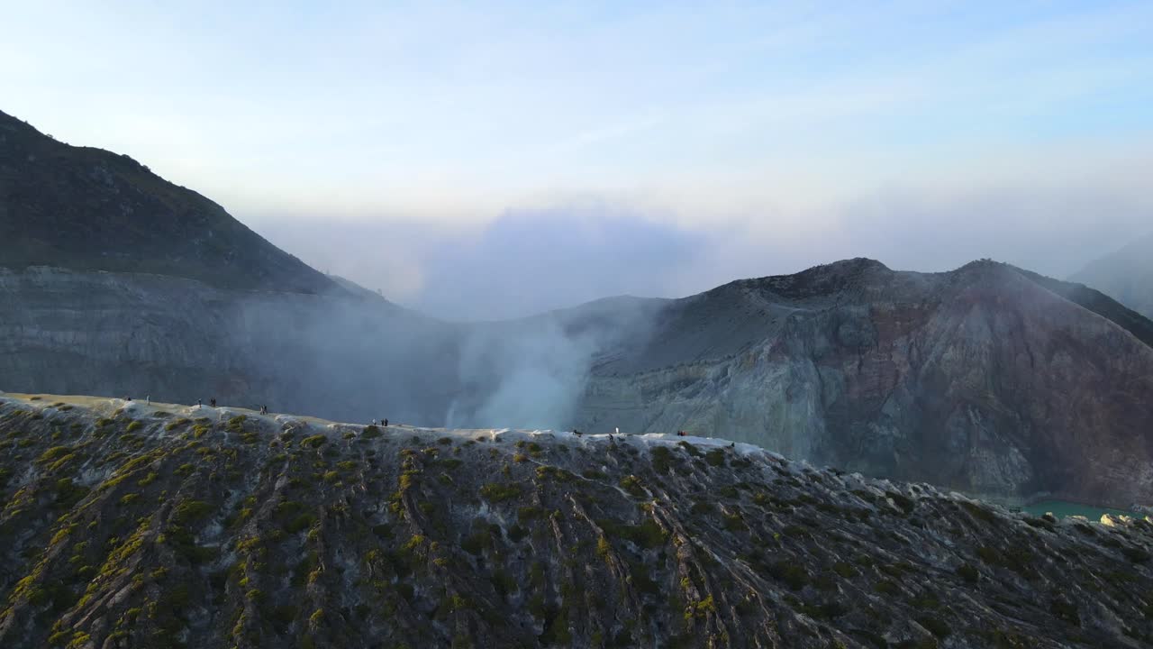 Drone showing people walking at the cliffside at the mouth of Ijen volcano in Java Indonesia