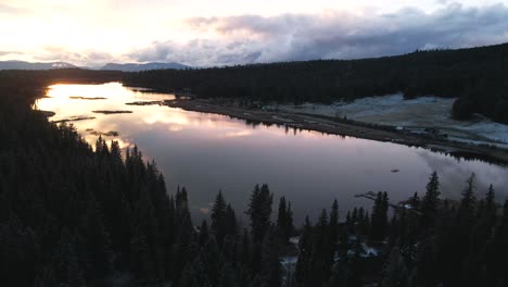 Remarkable-Aerial-Scene-of-Glimpse-Lake-during-golden-hour-sensational-reflections-of-the-clouded-sky-in-the-calm-lake