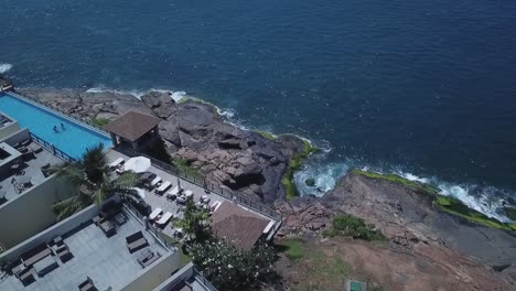 side part of leela hotel along kovalam beach in kerala, india - aerial descend