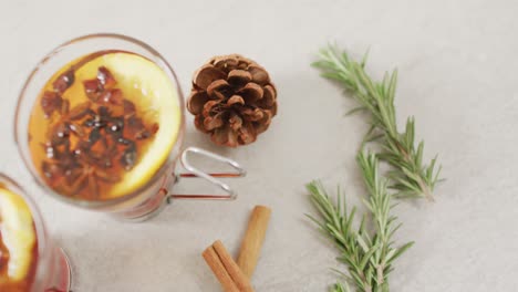 video of cups of hot tea with cinnamon and lemon over white background