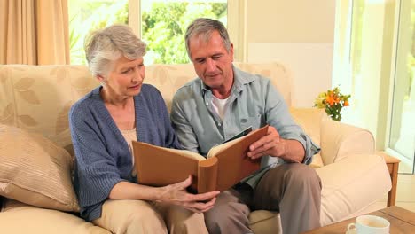 mature couple looking at an album