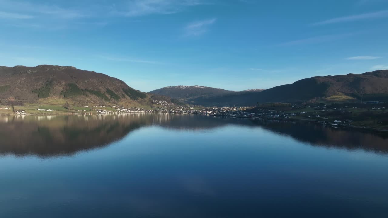 Aerial flying close to water surface towards Olen, Vindafjord, Norway