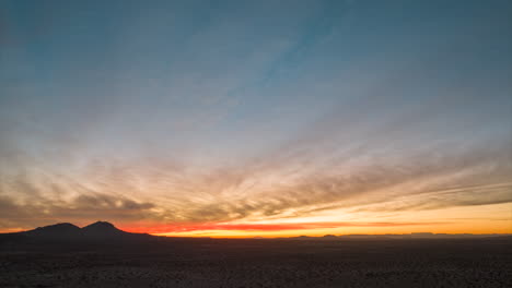 sunrise over the barren landscape of the mojave desert - aerial hyper lapse