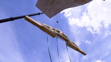 crane lifting wooden beams for construction