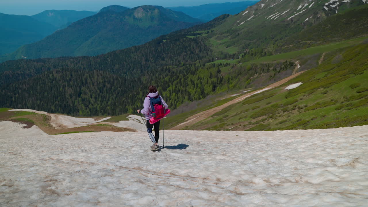 Woman Hiking in Snowy Mountains