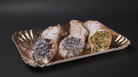 half circle shot of typical sicilian cannoli with cream plus chocolate and pistachio grannella