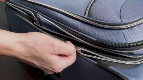 closing a suitcase zipper for a trip