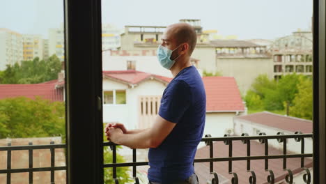 man during self isolation sitting on the balcony