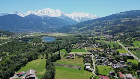 Mont-Blanc-Glacier,-Lake-Passy-and-Scenic-Road-in-French-Alps---Aerial-Reverse