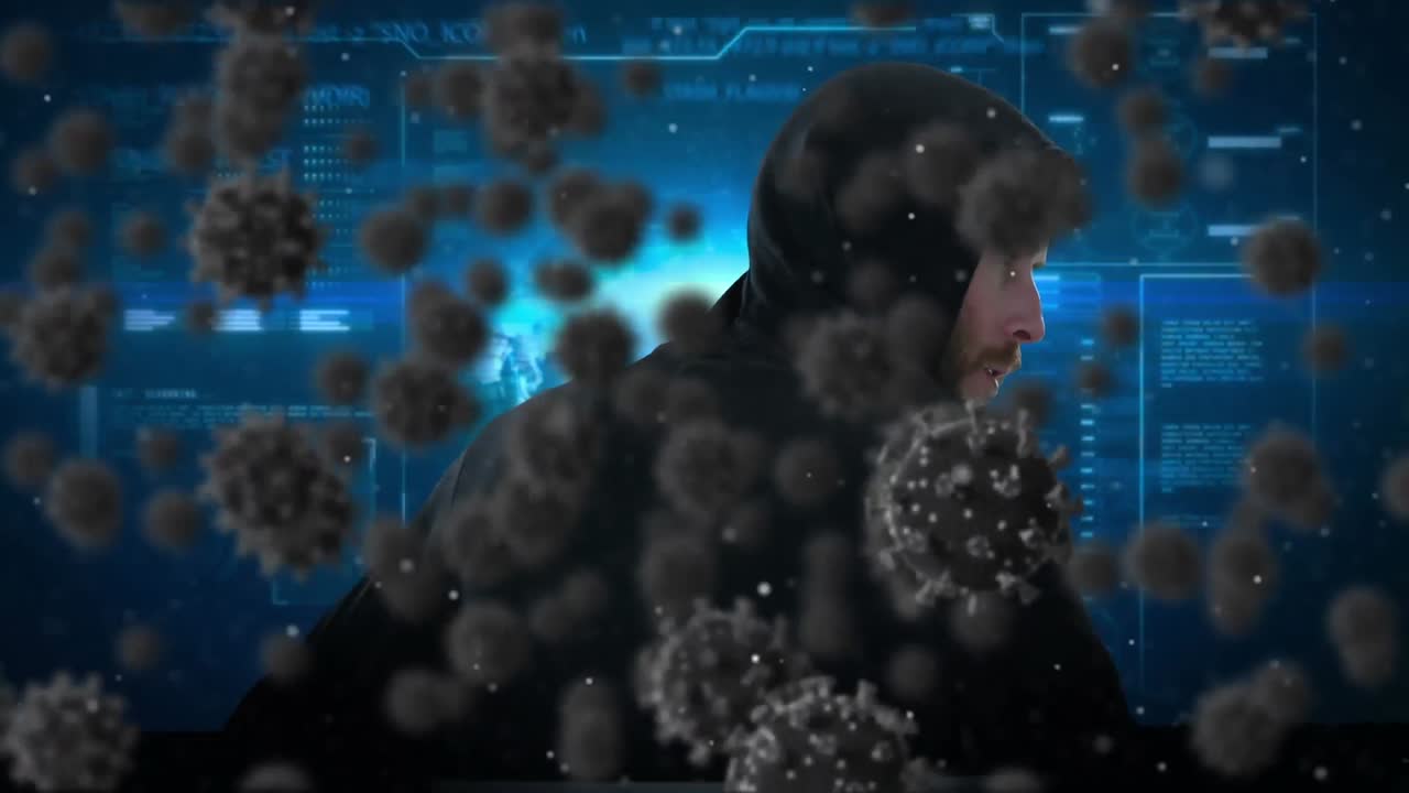 노트북을 사용하여 발라클라바를 입은 남성에 대한 거대한 코로나19 세포의 애니메이션