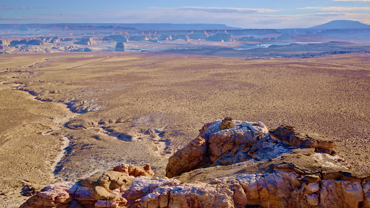 Drone shot flying around fascinating eroded rock formations of glen canyon and lake powell near Page Arizona