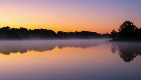 serene morning mist over calm water: a breathtaking sunrise landscape capturing the tranquility of nature's beauty and reflections in soft hues