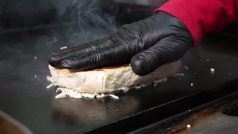 Melting-cheese-on-a-toasted-bun-for-a-cheesesteak-sub---food-truck-series