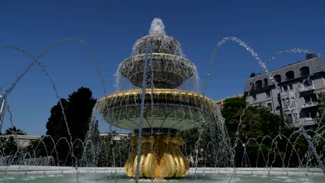 fountain classical form in three round bowls with cascade jets in city park.