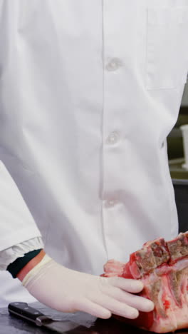 butcher arranging chopped red meat