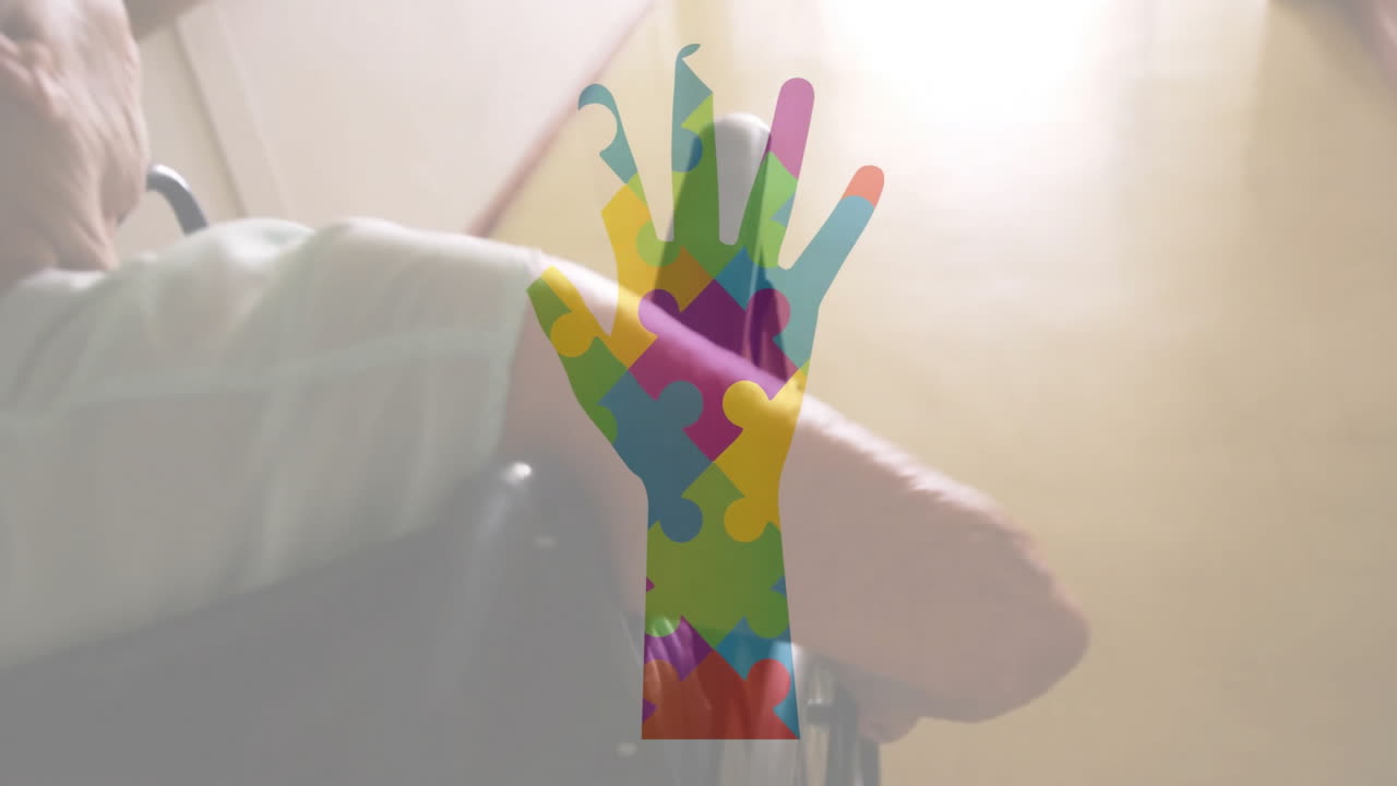 Animated colorful puzzle pieces over person in wheelchair with assisting hand