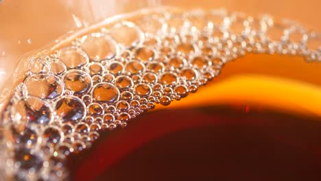 close up of bubbles in a glass of tea