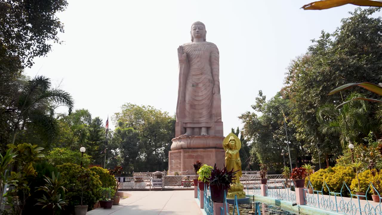 historic giant buddha carved in stone against bright sky