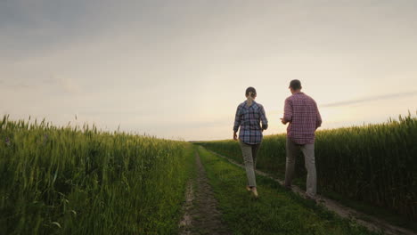 Two-Farmers-Communicate-In-A-Field-Of-Wheat-The-Woman-Speaks-On-The-Phone-My-Husband-Uses-The-Tablet