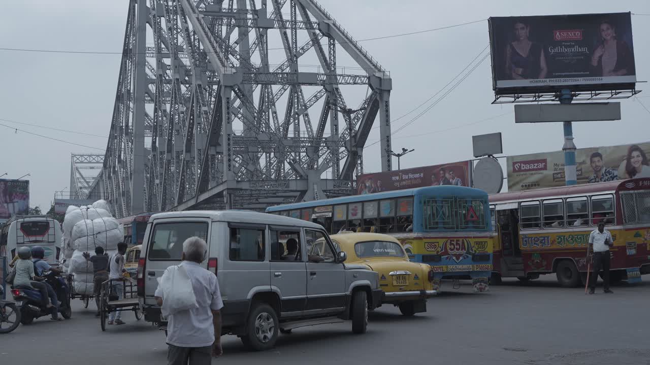 Howrah Bridge and bustling street traffic in Kolkata, India