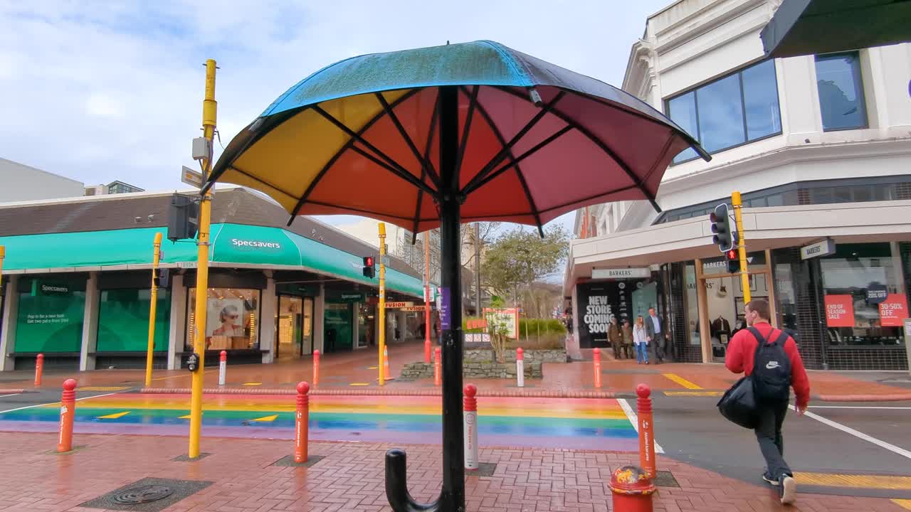 Colorful Umbrella Art Installation on a Rainbow Crosswalk
